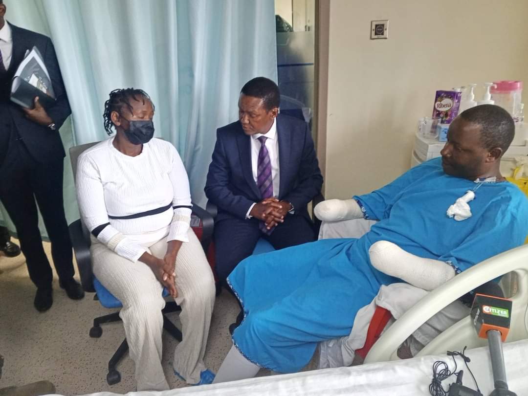 CS Alfred Mutua visits police officer who lost his hands while throwing teargas canister during protests in Nairobi. Photo/Alfred Mutua/X