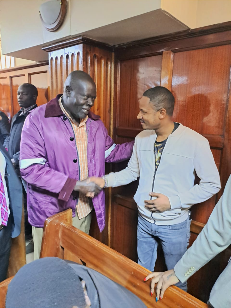 Embakasi East MP Babu Owino and Maverick Aoko's dad shake hands at the Milimani Law Courts after Maverick Aoko was released on a cash bail of Sh. 100, 000